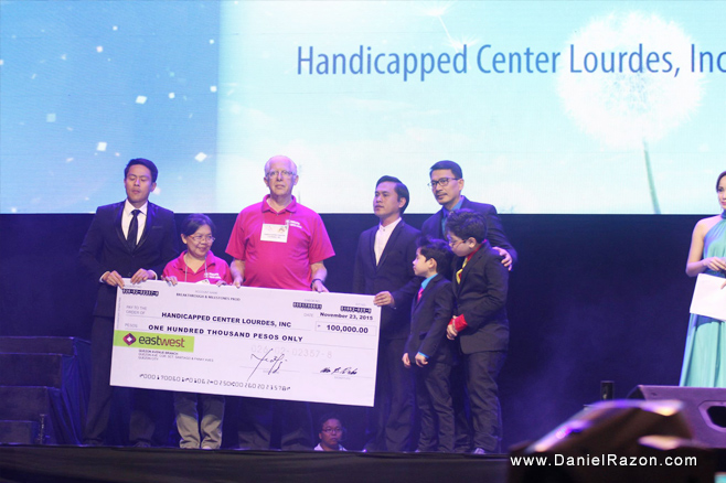 Handicapped Center Lourdes Inc, one of the 10 recipients of the “In the Eyes of a Child” concert, receives one hundred thousand pesos as financial aid.