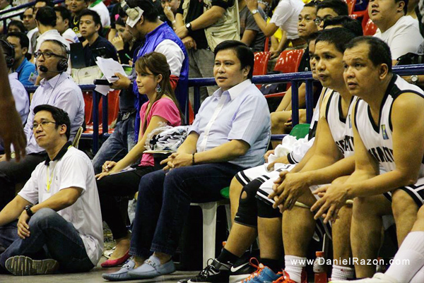 Senator Jinggoy Estrada shows his support for the Senate team as he sits at the Defenders bench during their match with the Philhealth Advocates.