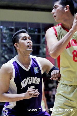 Ariel Capus (L) of Team Judiciary Magis puts up a defense against Paul Gerald Reguera (R) of Team DOJ Avengers during the UNTV Cup Season 2 Elimination Round held at the Meralco Gym, Ortigas, Pasig City, Philippines on 09 March 2014. Team Judiciary Magis wins over Team DOJ Avengers with the score 101-96. (Rey Calinawan Vercide | Photoville International)