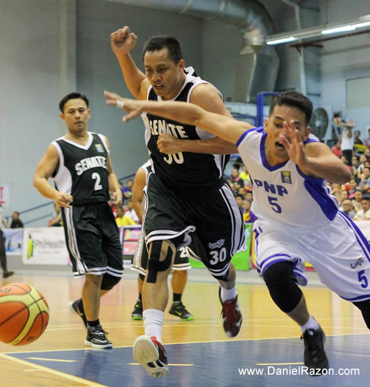 PNP point guard Japhet Cabahug (R) and Senate shooting guard Tata Marata (L) dashes to gain loose ball possession during the UNTV Cup Season 2 Elimination Round at the Ynares Sports Arena, Pasig City, Philippines on March 23, 2014. The PNP Responders demolishes the Senate Defenders with the score 93-53. ( Frederick Alvior | Photoville International)