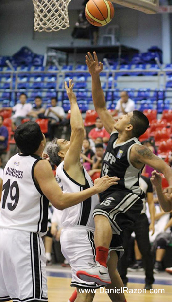 AFP Cavaliers Power Forward Wilfredo Tabingo Casulla, Jr. (R) goes against Senate Defenders Guard Ronald Golding (C) during the UNTV Cup Season 2 Second Round Eliminations at the Ynares Sports Arena, Pasig City, Philippines on 27 April 2014. (Photoville International/Maia Garciano)
